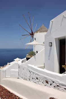 Whitewashed houses and windmill in Oia on Santorini island, Cyclades, Greece