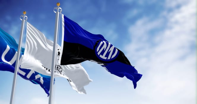 MIlan, IT, Sept. 10 2023: Flags of UEFA, UEFA CHampions League and Inter FC waving in the wind on a clear day. Illustrative editorial 3d illustration render. Fluttering fabric