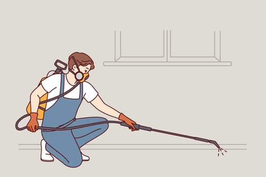 Man doing pest control using disinfection equipment and spraying liquid to kill insects. Employee of cleaning company in respirator makes disinfection of premises to get rid of rats and rodents.