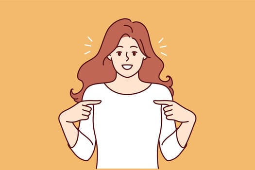 Happy woman pointing finger at t-shirt recommending good laundry detergent or bleach for clothes. Happy girl is proud of own achievements or success in career, and says yes its me.