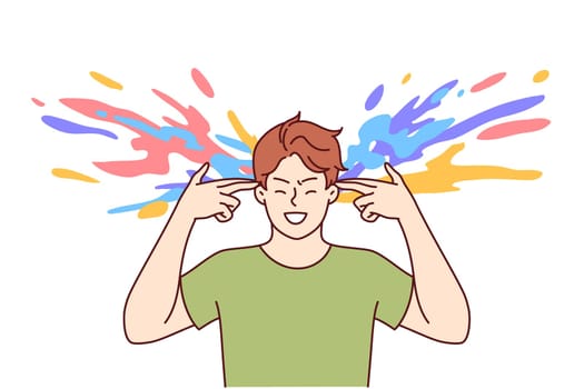 Man with creative thinking makes gesture of gun near head and colorful splashes, for concept of brainstorming. Positive guy coming up with ideas and brainstorming during rush of inspiration