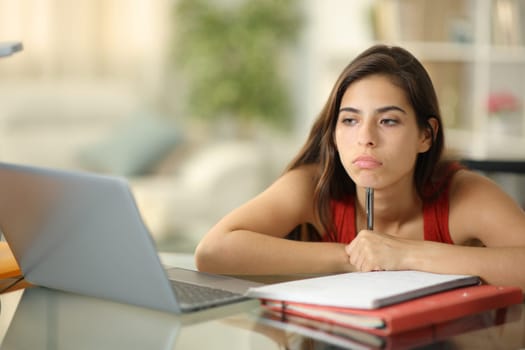 Bored student wasting time alone at home