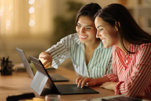 Tele workers working in the night using multiple devices at home