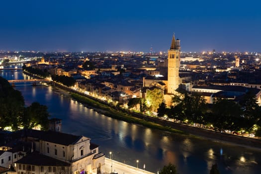 Verona, Italy - June 2022: panorama by night. Illuminated cityscape with scenic bridge