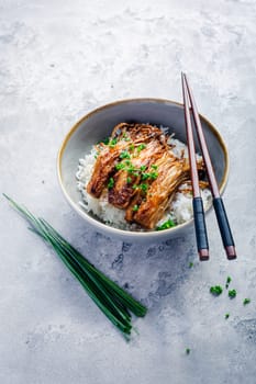 Rice with enoki mushrooms and chives. Asian vegan diet meal.