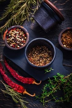 Cast iron spice mill for pepper, salt and herbs with ingredients