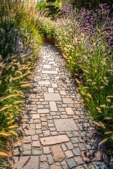 Modern pondless garden waterfall in a backyard with slate stones