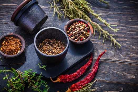 Cast iron spice mill for pepper, salt and herbs with ingredients
