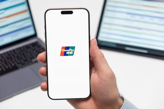 PRAGUE, CZECH REPUBLIC - JANUARY 21 2024: Union Pa logo on the screen of smartphone in mans hand on the workplace background.