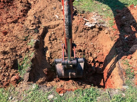 Backhoe to renovate the site in preparation for pouring the concrete slab. Construction concept