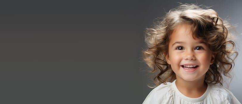 Portrait of a happy toddler girl, smiling child face, white shirt, baby and childhood concept, positive emotion