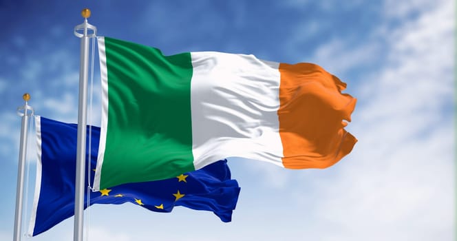 The flags of Ireland and the European Union fluttering together on a clear day. Ireland became a member of the European Union on 1973. 3d illustration render. International treaty and diplomacy