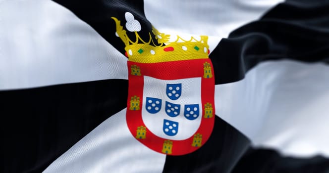 Ceuta flag waving on a clear day. Spanish autonomous city. Black and white gyronny with central escutcheon displaying the municipal coat of arms. 3d illustration render. Selective focus. Close-up