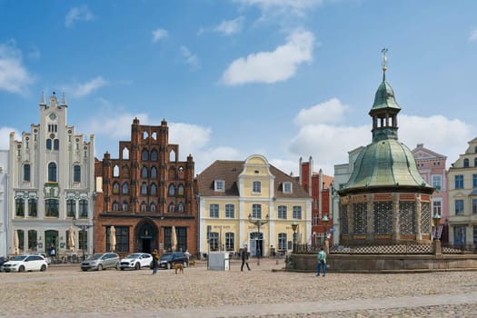 Market square in the old town of Wismar with the water art, Wasserkunst for the historical water supply of the city