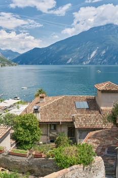 View over the roofs of the old town of Limone Sul Garda to the water of Lake Garda, Lago di Garda