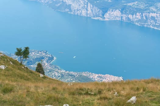 Breathtaking view from the top of Monte Baldo to the town of Malcesine below and the blue Lake Garda in Italy