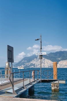 Pier for ferry service on the shore of Lake Garda in Malcesine Centro in Italy