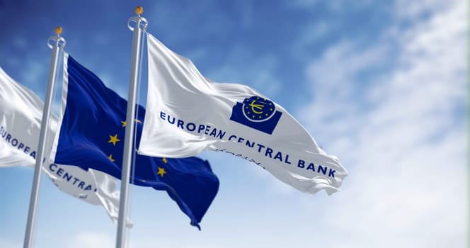 Frankfurt, DE, March 18 2023: Flags of the European Central Bank and European Union waving in the wind on a clear day. Illustrative editorial 3d illustration render