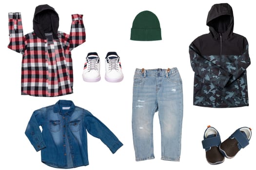 Collage set of little boys autumn clothes isolated on a white background. Denim trousers and jacket, sneaker, a down jacket, pants and hood for child boy. Children's winter fashion.