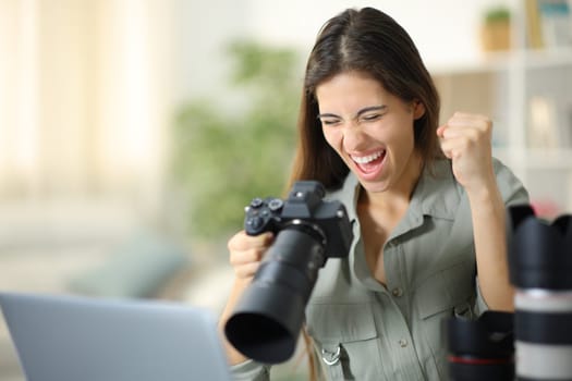 Excited photographer at home celebrating good result on camera
