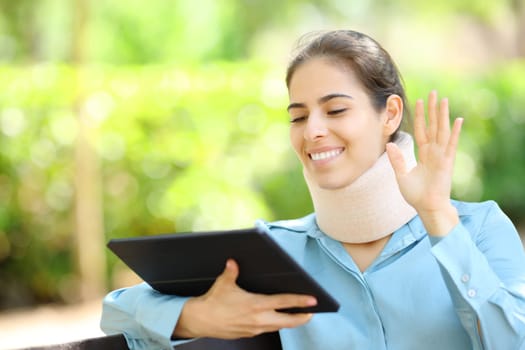 Convalescent businesswoman having videocall on tablet in a park