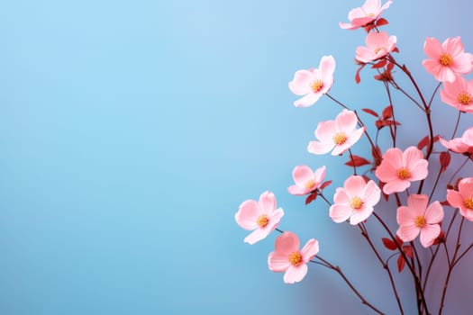 Pink stylish flowers on blue background. Copy space. AI generated