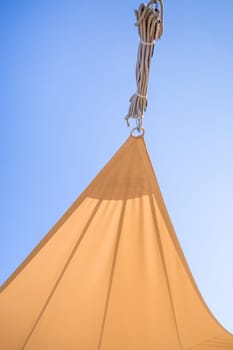 Detail of  sun shade sail or awnings against sunny blue sky for balcony or patio