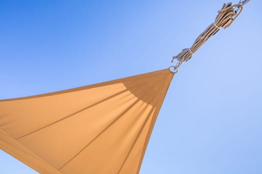 Detail of  sun shade sail or awnings against sunny blue sky for balcony or patio