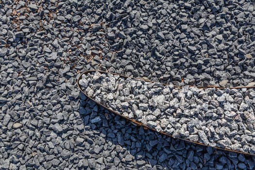 Dark gravel pebbles stone texture for modern garden design, stone garden