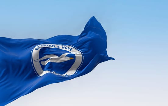 Brighton, UK, Aug. 23 2023: Brighton football club waving in the wind on a clear day. English professional football team. Illustrative editorial 3d illustration render. Rippled fabric