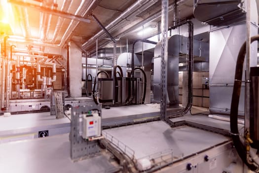 Interior industrial gas boiler with lot of piping, pumps and valves