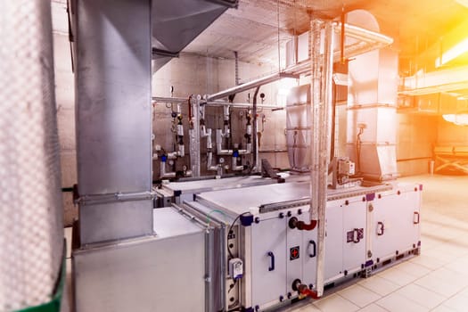 Interior industrial gas boiler with lot of piping, pumps and valves