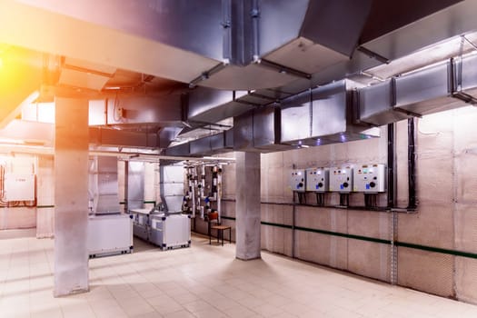 Interior industrial gas boiler with lot of piping, pumps and valves