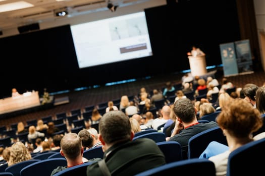Speaker giving a talk on scientific conference. Audience at the conference hall. Business and Entrepreneurship concept