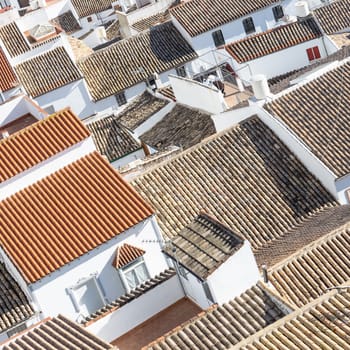 Aerial panoramic view of rooftops of white houses of Olvera town, considered the gate of white towns route in the province of Cadiz, Spain.