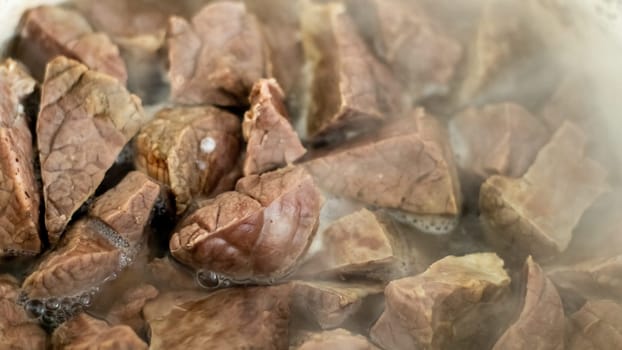 Pork lung in boiled hot water. Close-up of the preparation of a Thai dish. Boiled bovine or beef lungs, pork entrails