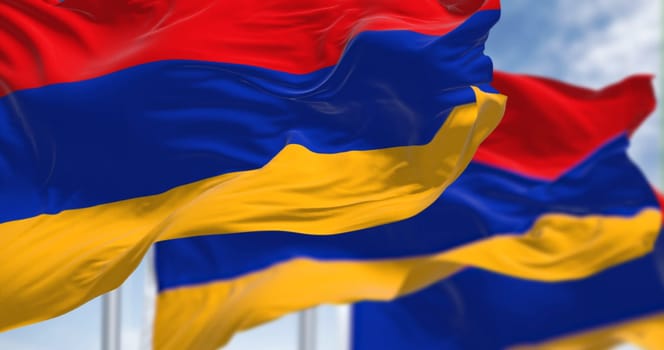 Three Armenia national flags waving in the wind. Three horizontal bands in red, blue and apricot. 3d illustration render. Rippled fabric. Selective focus