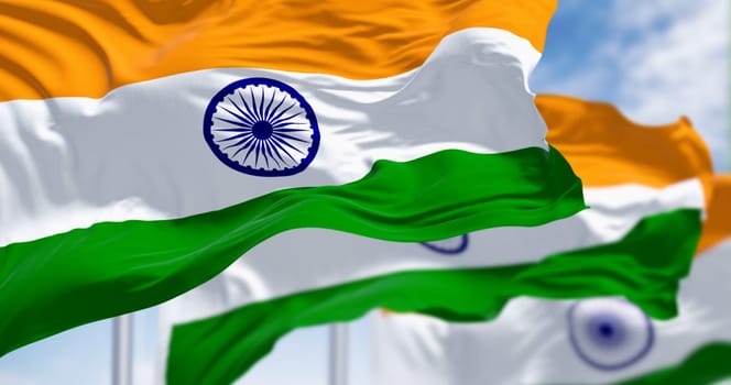 National flags of India waving on a clear day. Tricolor of saffron, white and green with a blue Ashoka Chakra in the center. 3d illustration render. Selective focus. Fluttering textile