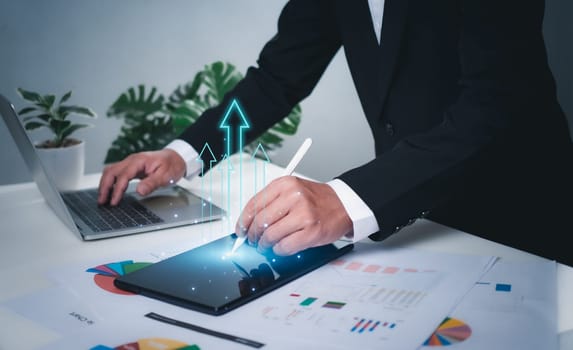 Business development concepts for success and growth. Businessman taps pen on tablet for planning future growth of his organization, finance, management, plans, management, strategy
