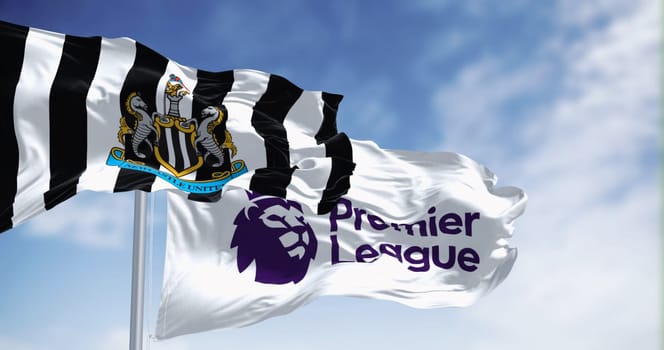 Newcastle, UK  sept. 14 2023: Newcastle Football Club and Premier League flags waving together on a clear day. Illustrative editorial 3d illustration render. Fluttering fabric. Selective focus