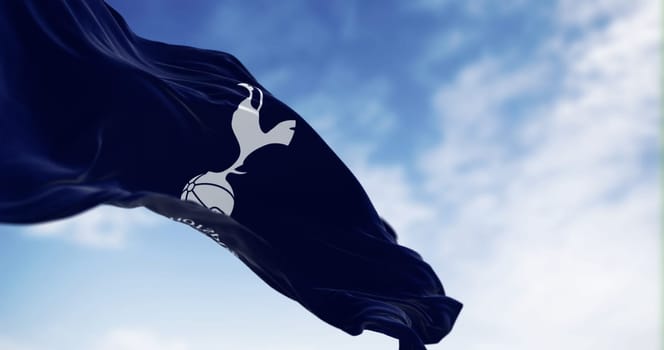 London, UK, aug 30 2023: Tottenham Hotspur flag waving. White cockerel standing on a football. Rippled fabric background. Illustrative editorial 3d illustration render. Selective focus.
