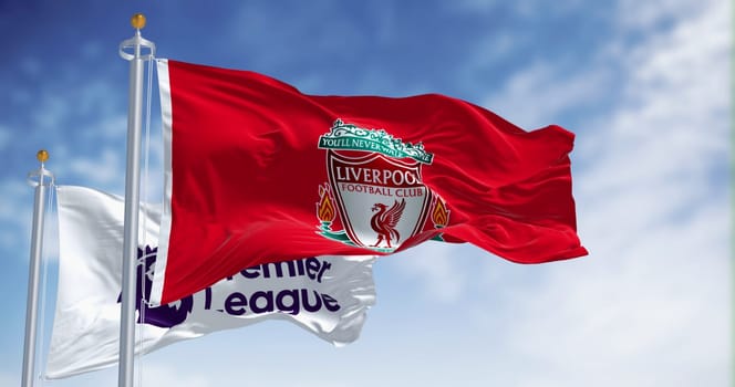 Liverpool, UK  sept. 14 2023: Liverpool Football Club and Premier League flags waving together on a clear day. Illustrative editorial 3d illustration render. Fluttering fabric. Selective focus