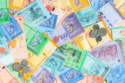 Malaysia currency of Malaysian ringgit banknotes and coins background. Sen coins of fIve, ten, twenty and fifty on paper money of one, five, ten, twenty, fifty and hundred ringgit notes.
