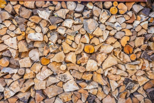 Close up of logs stored to dry for use in a log burner, firewood