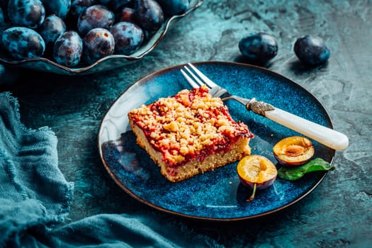 Homemade vegan German plum cake (Zwetschgenkuchen) with yeast dough and crumbles
