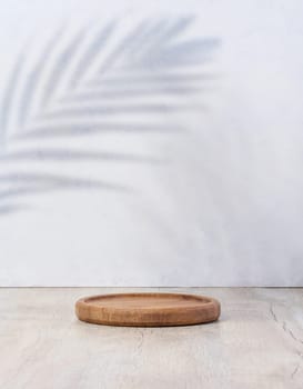 Wooden empty decorative plate on white background, product and cosmetic display stage, copy space