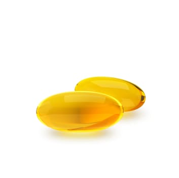 Golden oil capsule of vitamin A, E, Omega 3 or collagen. of medical pill with fish fat or organic cosmetic oil on white background