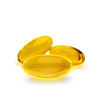 Golden oil capsule of vitamin A, E, Omega 3 or collagen. of medical pill with fish fat or organic cosmetic oil on white background
