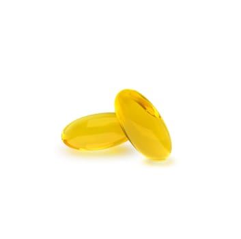 Golden oil capsule of vitamin A, E, Omega 3 or collagen. of medical pill with fish fat or organic cosmetic oil on white background