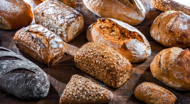 Assorted bakery products including loaves of bread and rolls